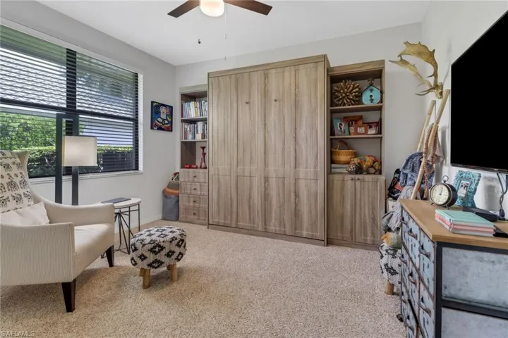Living area featuring ceiling fan and light carpet