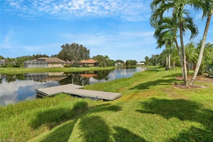 Dock area featuring a lawn and a water view