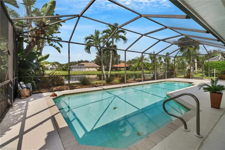 View of pool featuring a patio, a water view, and a lanai