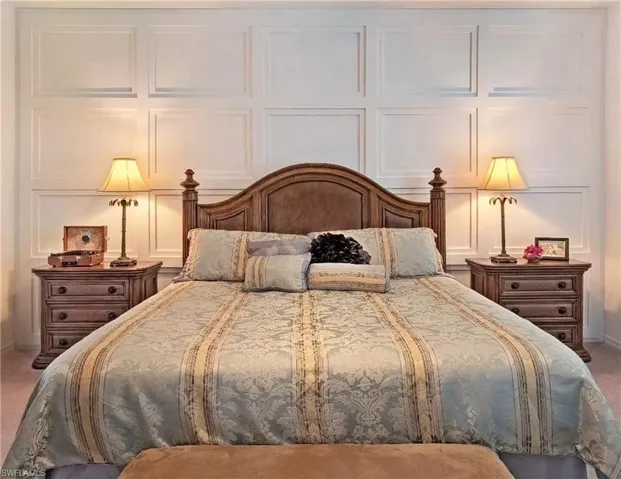 Bedroom featuring a decorative wall and carpet flooring
