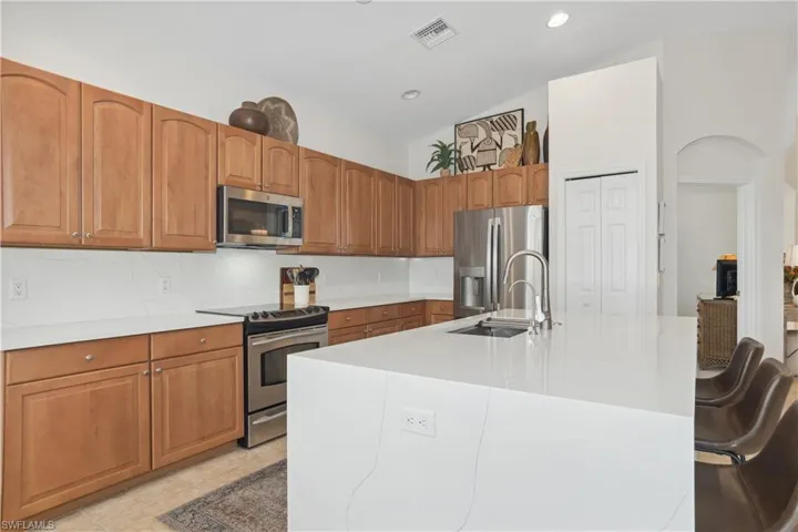 Island kitchen with quartz counter tops