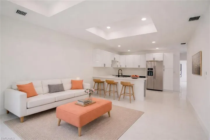 Unit A Photos include virtually enhanced appliances. Range is a front-control model without a rear panel, providing a full view of the backsplash.
