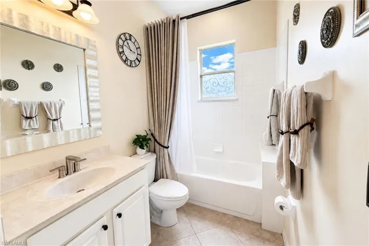 Bathroom featuring a vanity with a light-toned countertop, undermount sink, and brushed nickel faucet