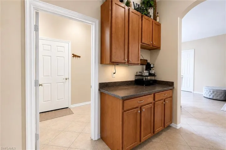 Built-in cabinetry with wood-finish doors and dark countertops