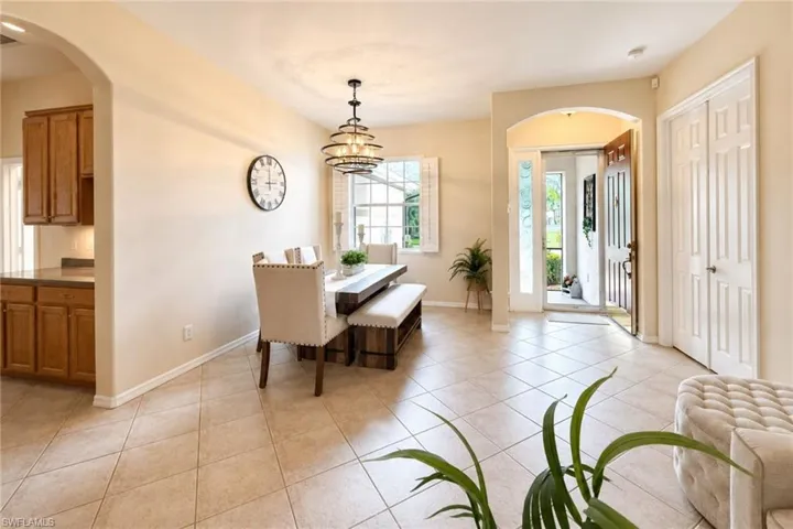 Open concept dining area featuring neutral wall tones and diagonal tile flooring