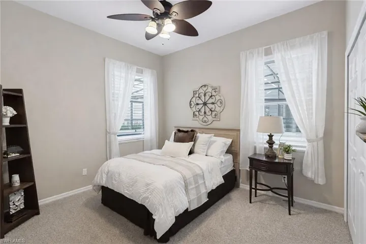 Neutral wall tones with a dark-bladed ceiling fan