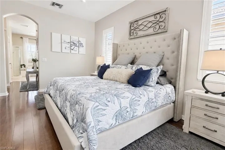 Spacious bedroom featuring wood-finish flooring and a neutral color palette