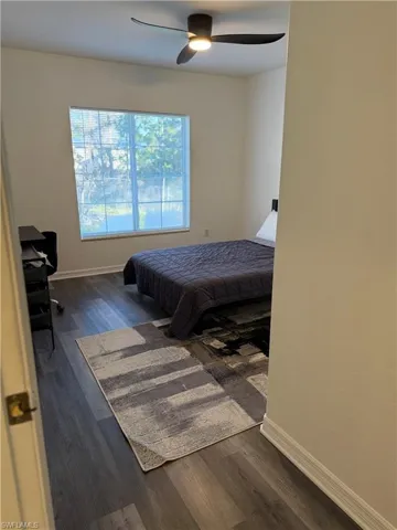 Bedroom with dark wood finished floors and a ceiling fan