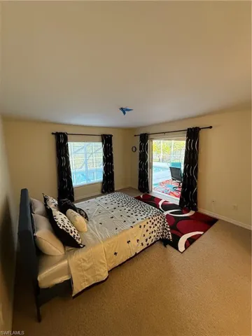 Bedroom featuring carpet and access to exterior