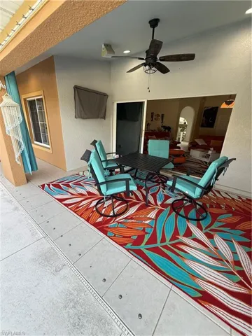 View of patio with ceiling fan and outdoor dining space