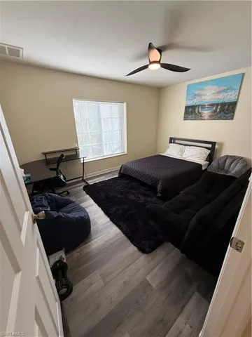 Bedroom featuring wood finished floors and ceiling fan