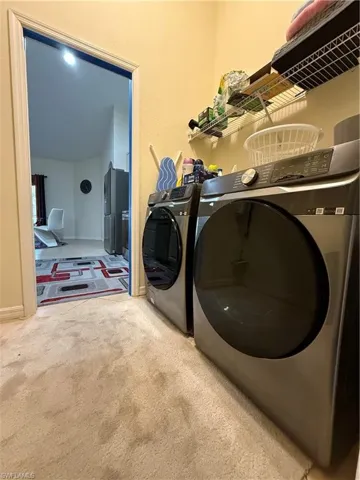 Washroom featuring carpet flooring and washer and dryer