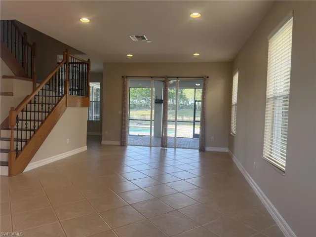 Unfurnished living room with recessed lighting, visible vents, baseboards, and tile patterned flooring