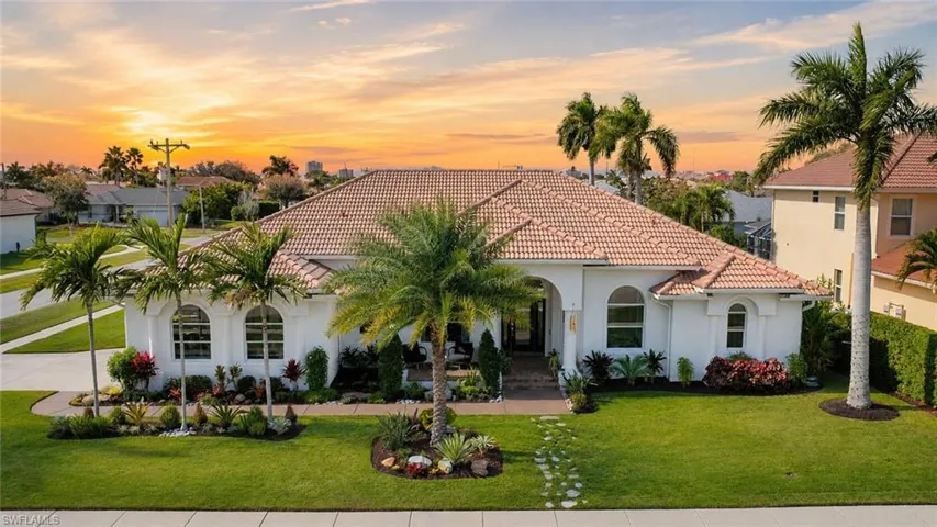 Mediterranean-style residence featuring a tile roof and stucco exterior
