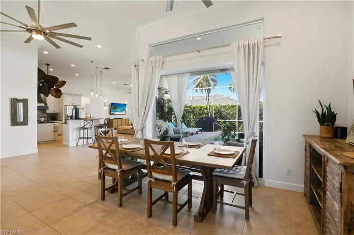Dining space with ceiling fan, light tile patterned floors, and recessed lighting