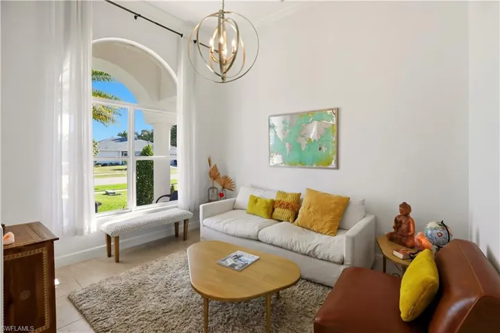 Living area featuring a chandelier and tile patterned flooring