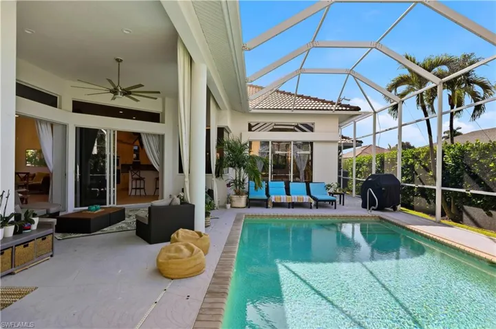 Outdoor pool featuring a lanai, a grill, and a sunroom