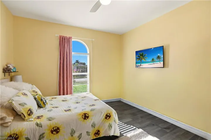 Bedroom featuring dark wood-style floors and a ceiling fan