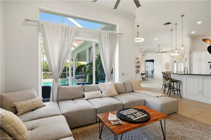Living room featuring ceiling fan, light tile patterned floors, plenty of natural light, and recessed lighting