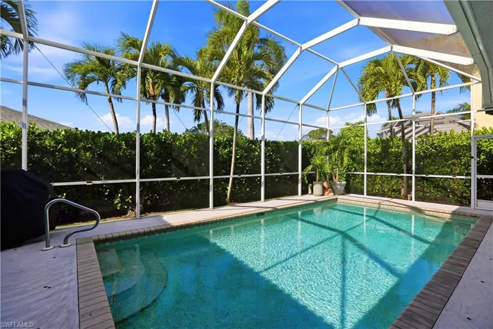 Outdoor pool featuring a lanai, a grill, and a sunroom