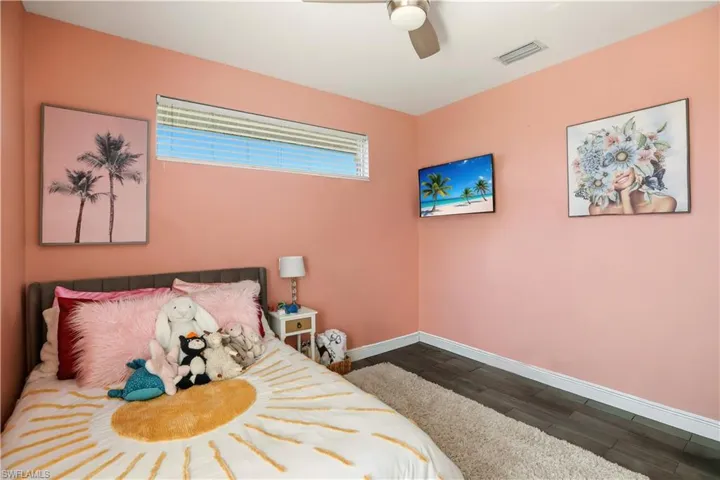 Bedroom with dark wood-style floors and a ceiling fan