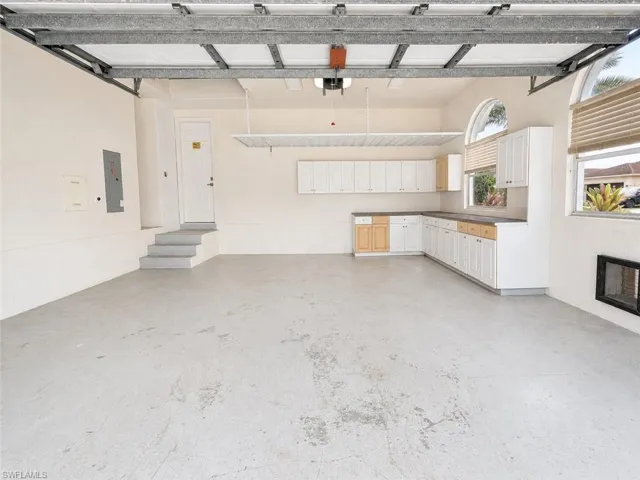 Spacious garage featuring concrete flooring and a fully functional garage door opener