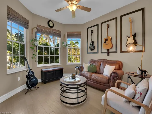 Bedroom featuring light bamboo flooring, a wealth of natural light, and ceiling fan