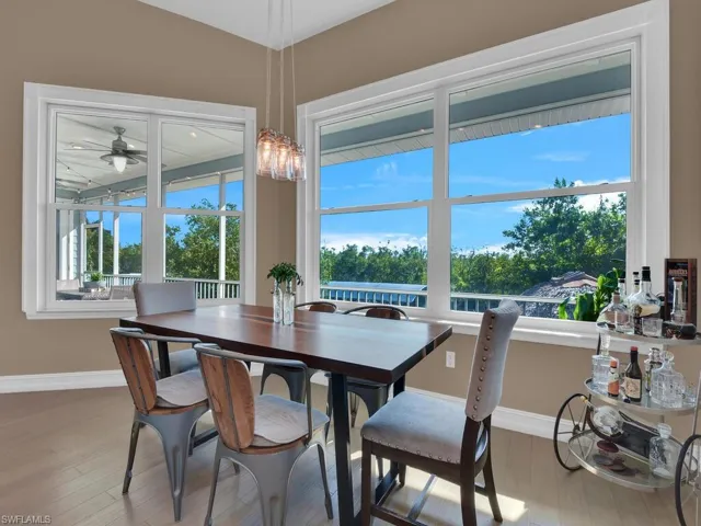 Dining space with hardwood / wood-style flooring and ceiling fan