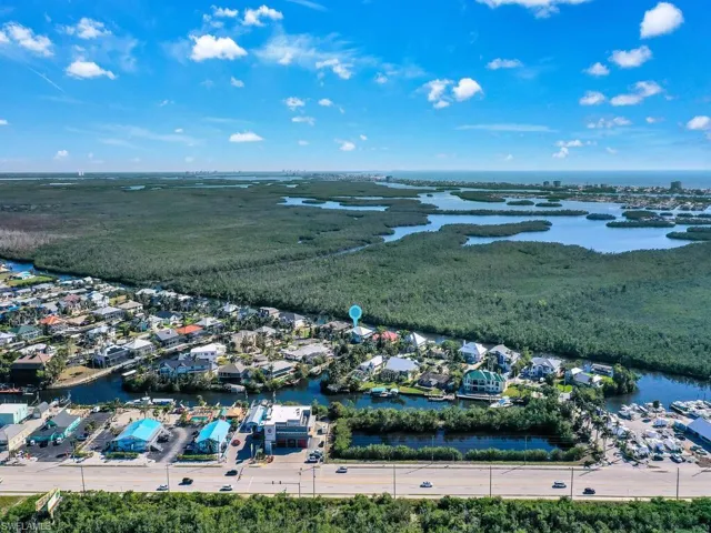Birds eye view of property with a water view
