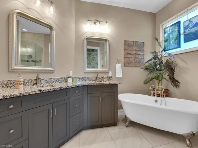 Bathroom featuring vanity, tile patterned floors, and separate shower and tub