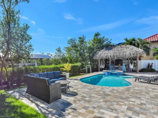 View of swimming pool featuring a patio area, an in ground hot tub, and outdoor lounge area