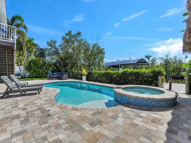 View of pool with outdoor lounge area, an in ground hot tub, and a patio