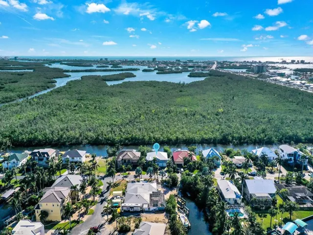 Birds eye view of property with a water view
