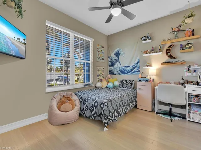 Bedroom featuring light bamboo flooring and ceiling fan