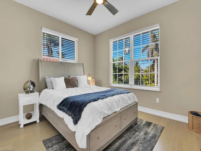 Bedroom with ceiling fan and light hardwood / wood-style flooring
