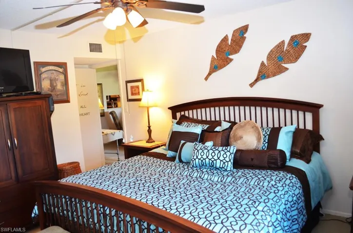 Bedroom with ceiling fan and baseboards