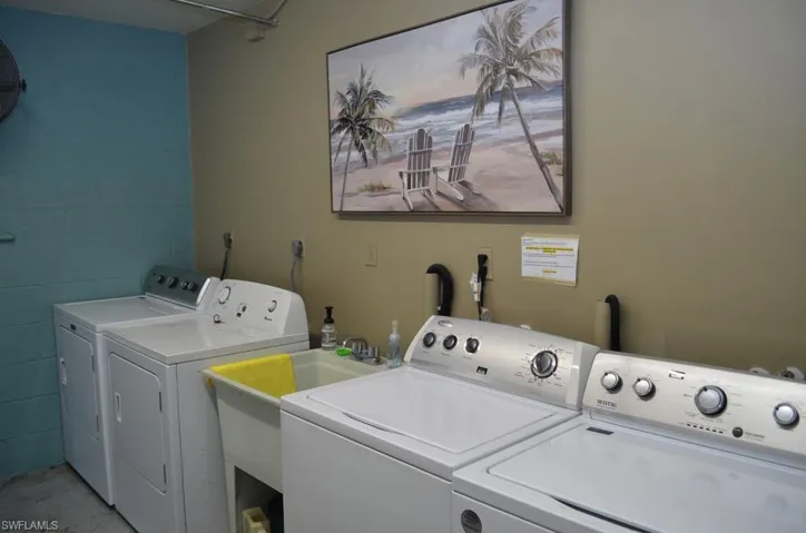 Washroom with independent washer and dryer and concrete block wall