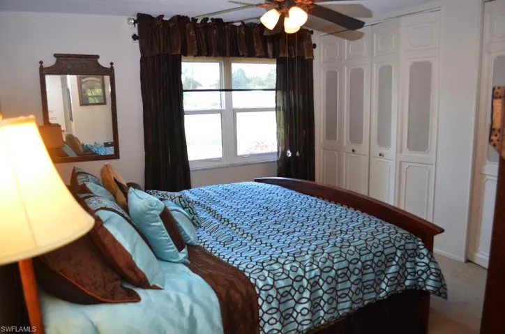 Bedroom with carpet floors, a closet, and a ceiling fan