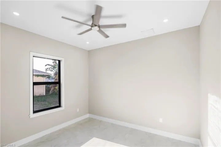 Spare room featuring ceiling fan, recessed lighting, and light marble finish floors