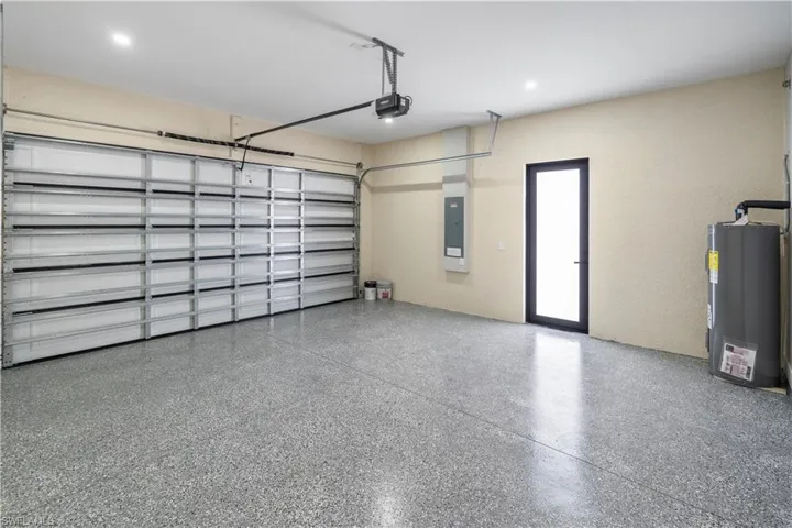 Garage with water heater and electric panel
