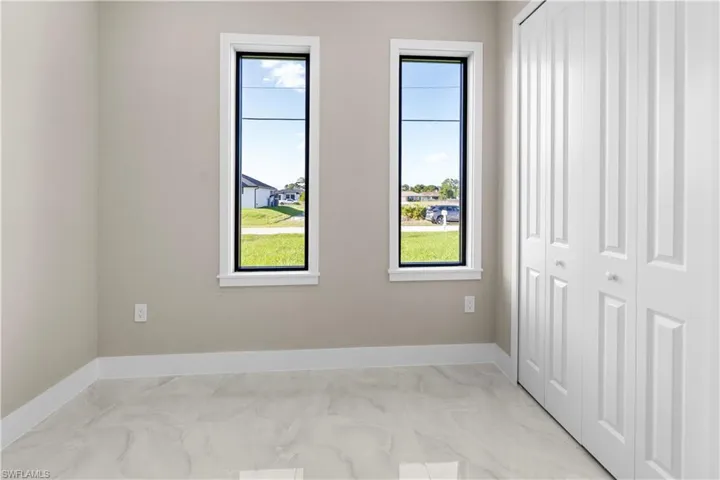 Unfurnished bedroom with a closet and baseboards