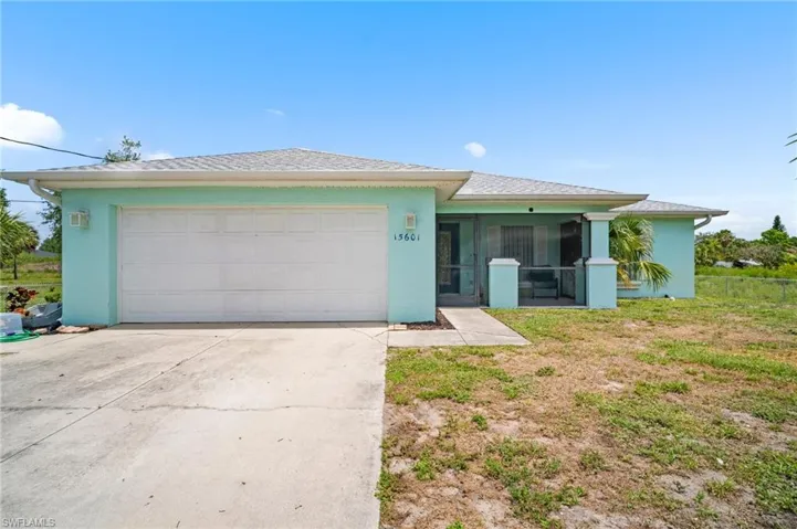 View of front of house with concrete driveway, stucco siding, and an attached garage