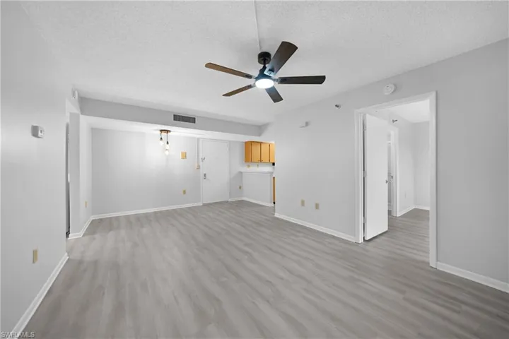 Great room featuring ceiling fan, hardwood / wood-style flooring, and a textured ceiling