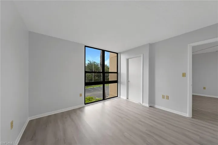 Empty room featuring light hardwood / wood-style floors and floor to ceiling windows