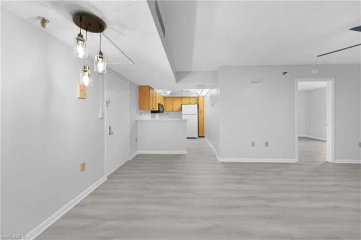 Unfurnished living room with a textured ceiling and light wood-type flooring