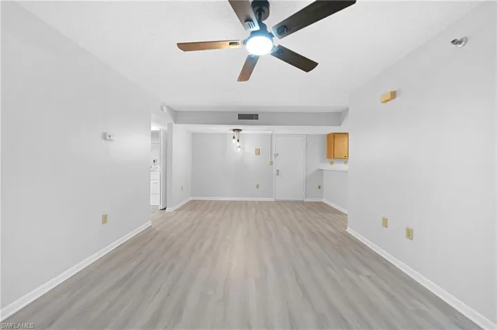 Great room with ceiling fan and light hardwood / wood-style floors