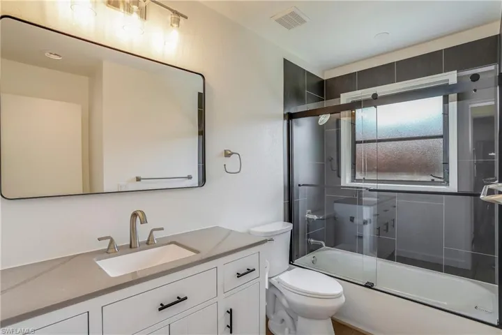 Bathroom featuring a white vanity with a light-toned countertop