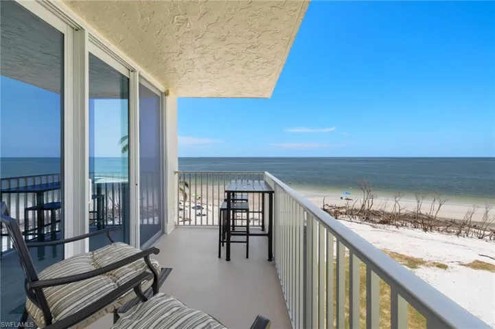 Balcony featuring a view of the beach