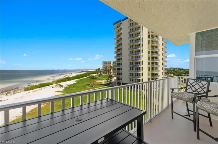 Balcony featuring a view of the beach