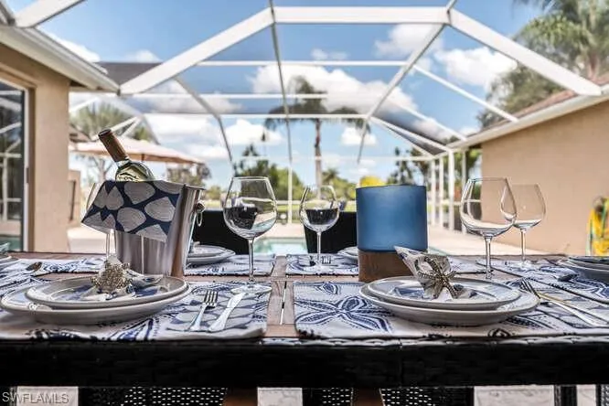 View of patio featuring glass enclosure and a swimming pool